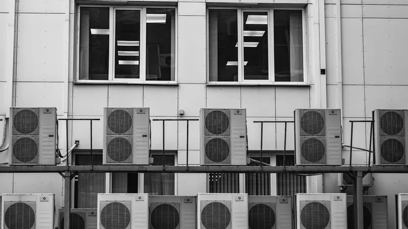 A row of air conditioners in front of a building — stock photo