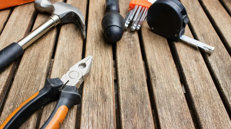 Assorted-type carpentry tools on brown surface — stock photo