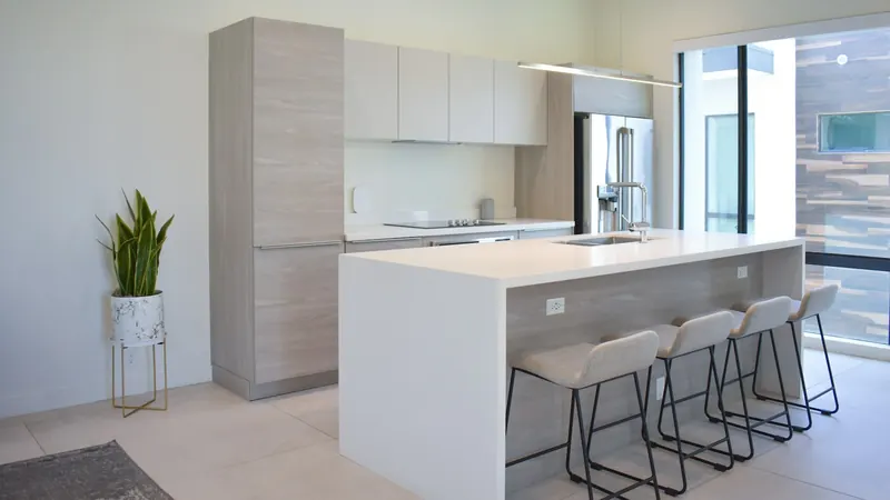 A kitchen with a center island with four stools — stock photo